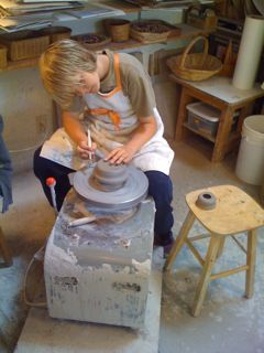 Gabriel, trimming Gabriel trimming his pot on the potter's wheel