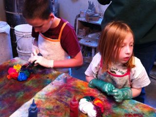 Tie-dye T-shirts Two children applying colored dye to t-shirts